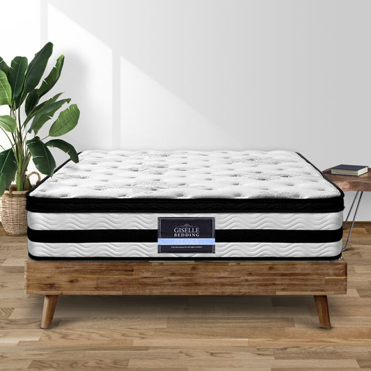 A 34cm thick super king-sized mattress with Euro Top pocket springs, displayed on a wooden bed frame in a room setting, with a plant and a lamp in the background.