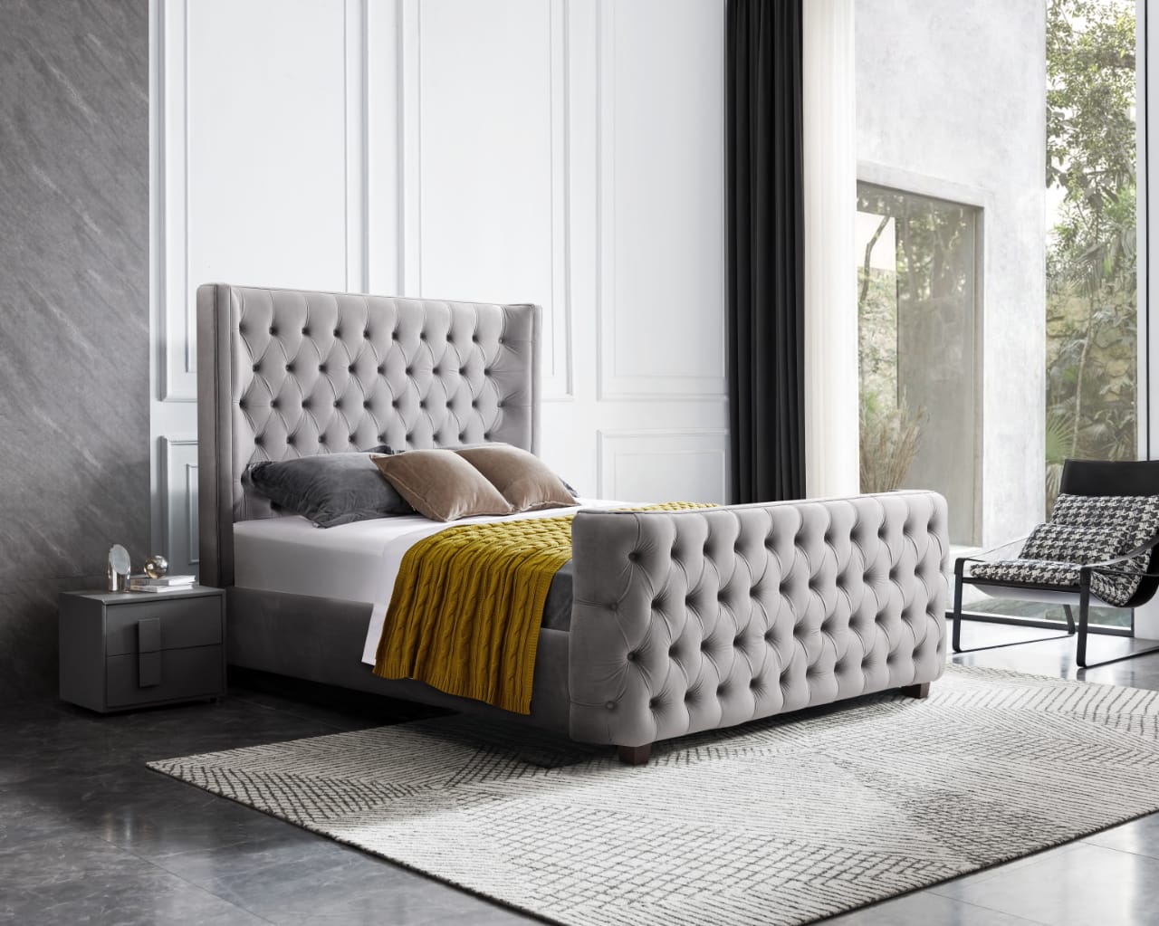 Gray upholstered bed with tufted design in a modern bedroom setting.