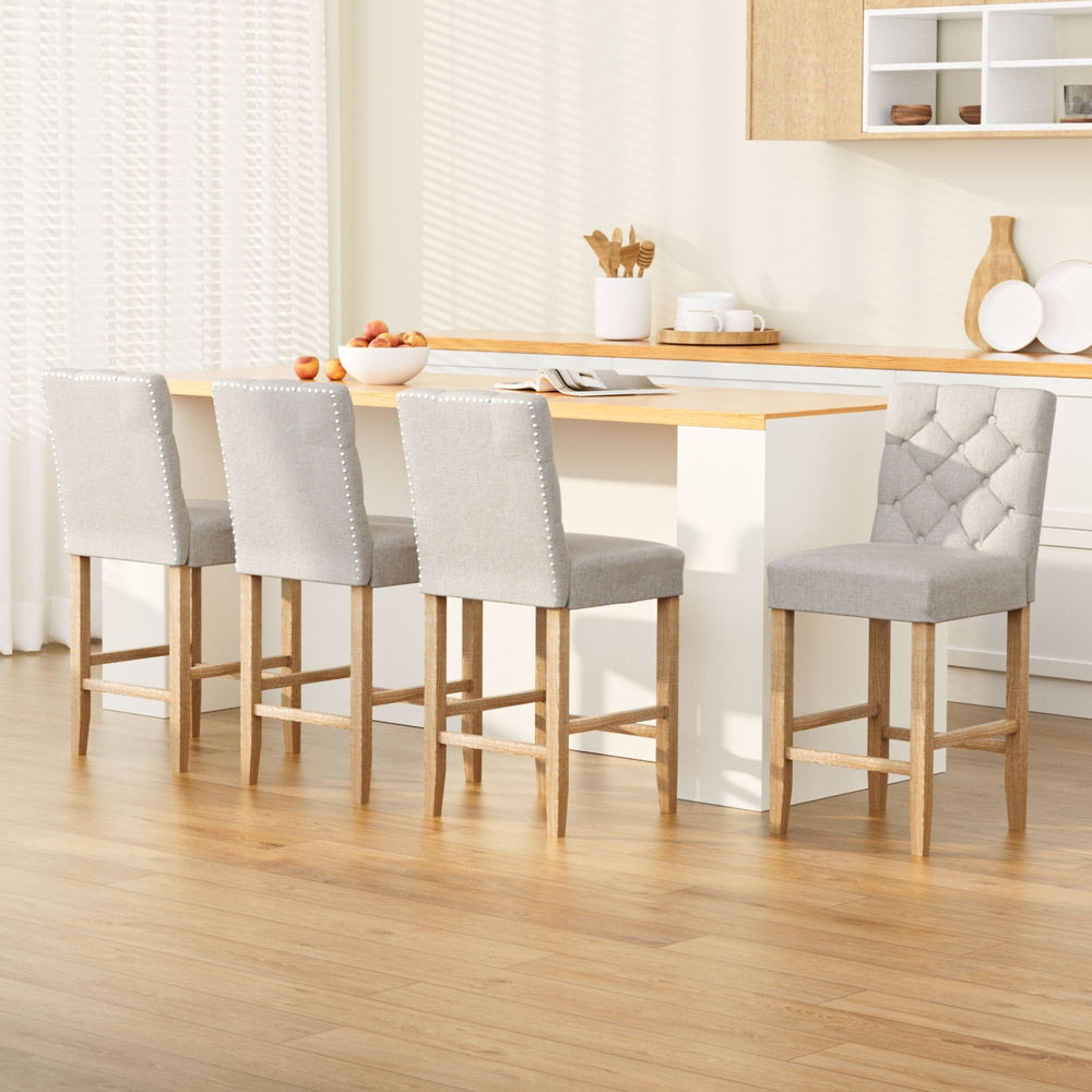 Artiss 4x Bar Stools Linen Upholstered Chairs

Experience the epitome of luxury with Artiss 4x Linen Upholstered Bar Stools. These expertly crafted barstools feature a tufted button design, adding warmth and sophistication to any modern living space. The unique copper nail head trim adds a touch of metallic elegance, while the sturdy wooden structure, comfortable padding, sinuous spring support, and rubberwood legs ensure stability and comfort. With a high backrest and built-in footrest, these barstools pro
