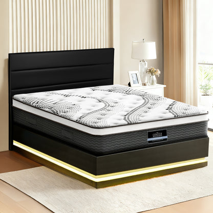Black and white mattress with visible brand logo in a bedroom setting