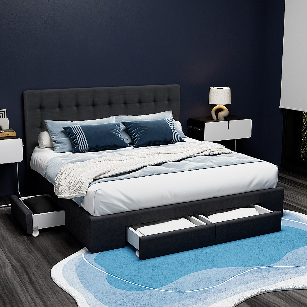 Black upholstered bed with storage drawers in a bedroom setting.