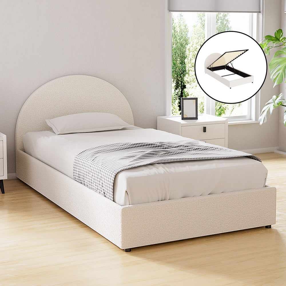 Beige upholstered bed in a room with a window and plant