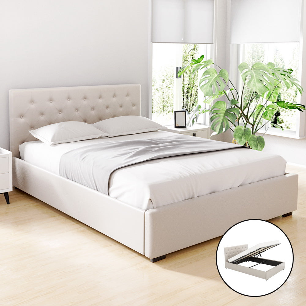 A beige upholstered Artiss VILA Bed Frame with a tufted headboard, storage compartment, and a wooden arched slat base in a bedroom setting.