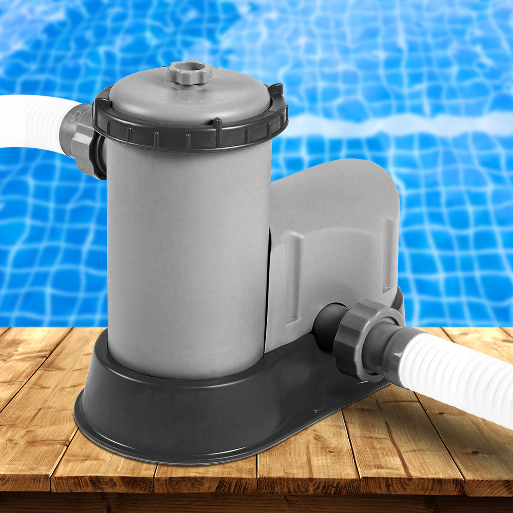 Pool filter pump on a wooden deck with a pool in the background