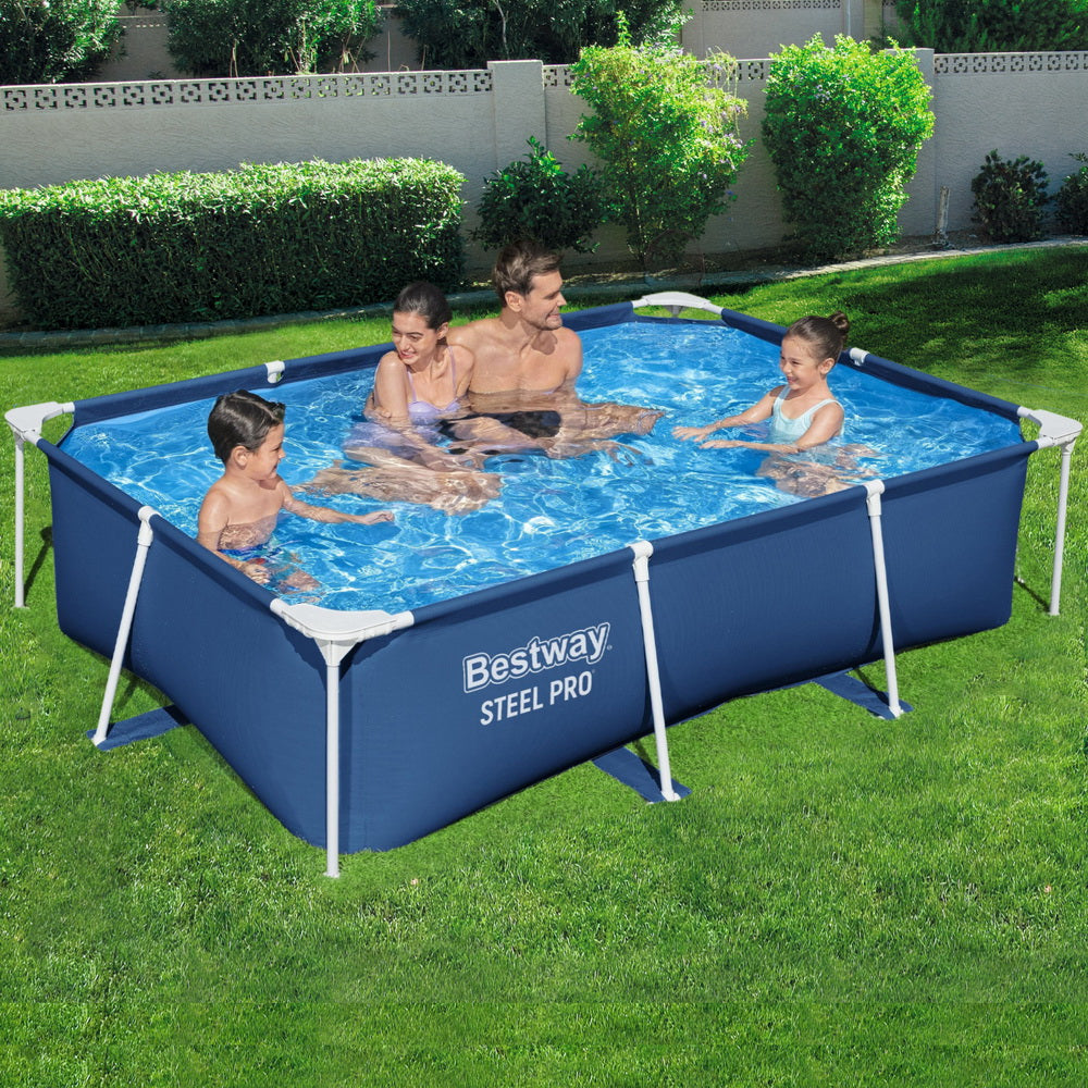 Family playing in a Bestway Steel Pro rectangular pool on a grassy lawn.