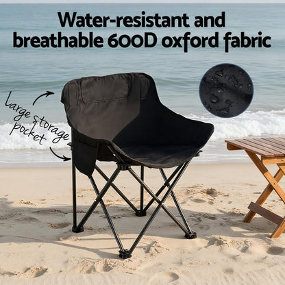 Black camping chair on a sandy beach with text highlighting features like water-resistance, breathable fabric, and large storage pocket.