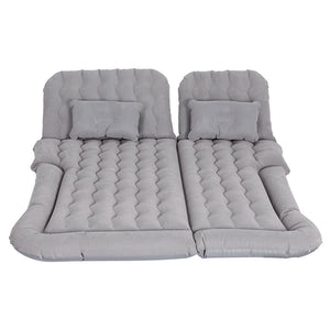 Inflatable car mattress and pillows in gray, laid out on a flat surface.