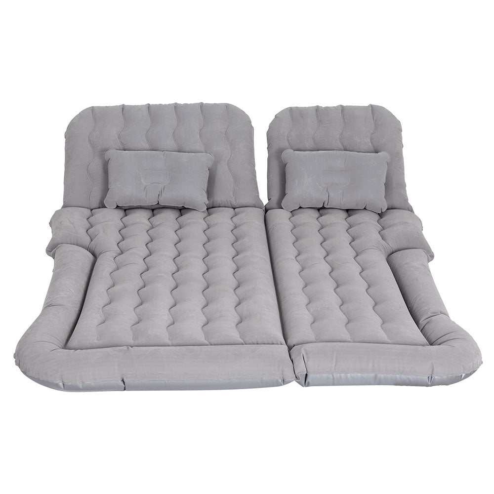 Inflatable car mattress and pillows in gray, laid out on a flat surface.