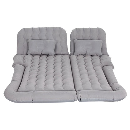 Inflatable car mattress and pillows in gray, laid out on a flat surface.