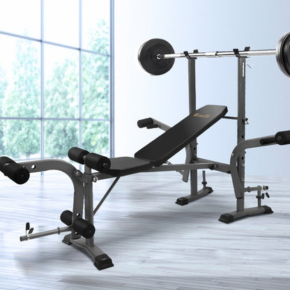 Weight bench and barbell set in a home gym setting with large windows.