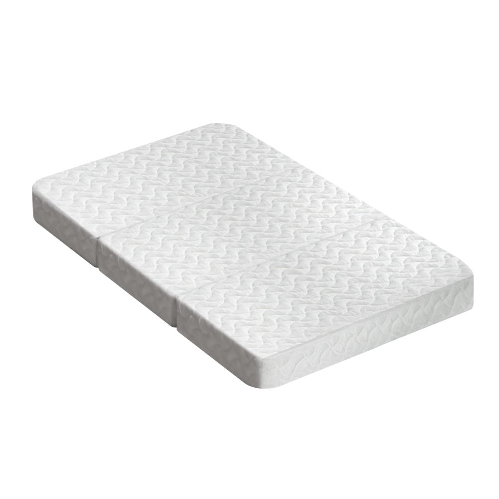 Foldable white foam mattress for babies, displayed unfolded.