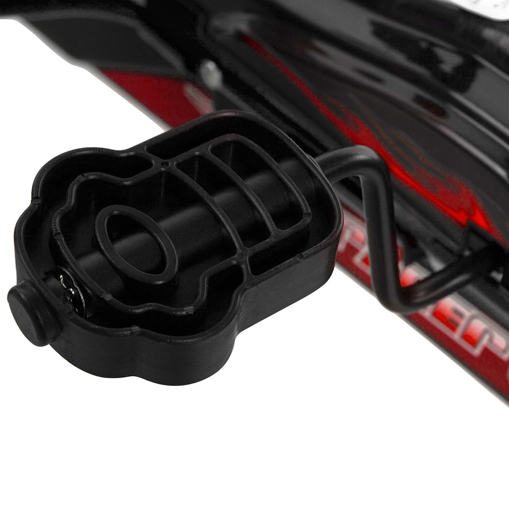 Black bike pedal attached to a bicycle frame with red accents