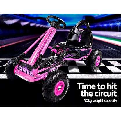 Pink and black pedal go-kart on a racetrack with text about weight capacity.