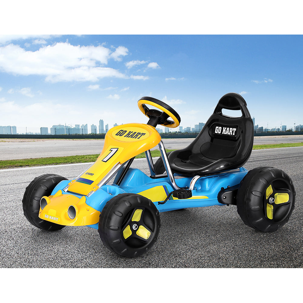 Yellow and blue go-kart on a road with a cityscape in the background