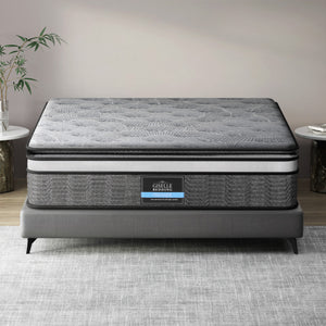 A double-layer pocket spring mattress by Giselle Bedding, displayed on a bed frame, with a quilted design on the surface.