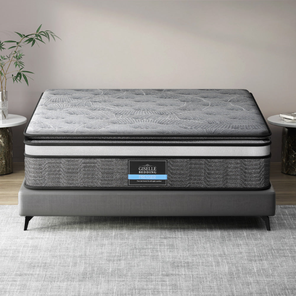 A double-layer pocket spring mattress by Giselle Bedding, displayed on a bed frame, with a quilted design on the surface.
