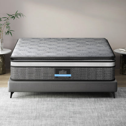 A double-layer pocket spring mattress by Giselle Bedding, displayed on a bed frame, with a quilted design on the surface.