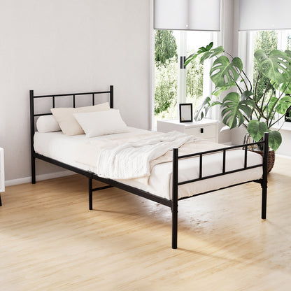 A single metal bed frame with a black finish, displayed in a room setting with a mattress and pillows on top.