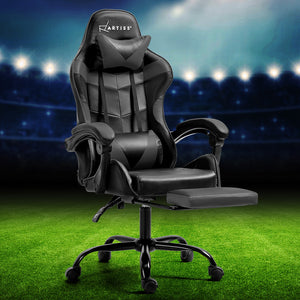 An Artiss gaming office chair in gray, featuring a high-back design with a footrest, situated on a green surface with a blurred sports arena background.