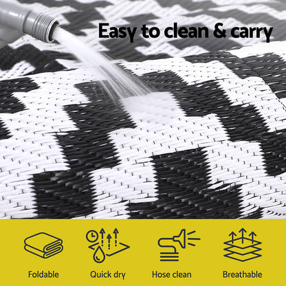 Black and white checkered mat with water being sprayed on it, labeled 'Easy to clean & carry'.