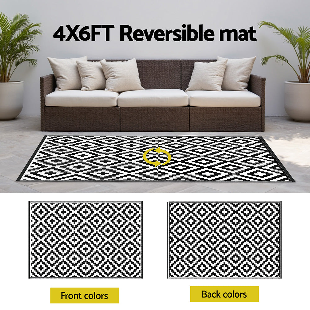 4X6FT reversible mat displayed in front of a sofa with patterned design.