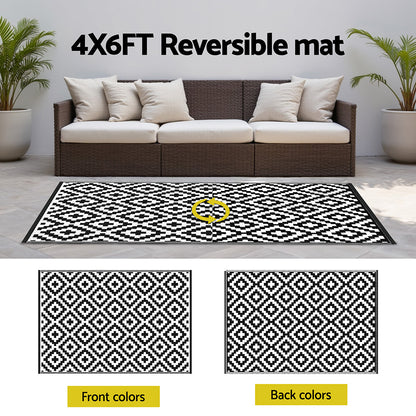 4X6FT reversible mat displayed in front of a sofa with patterned design.