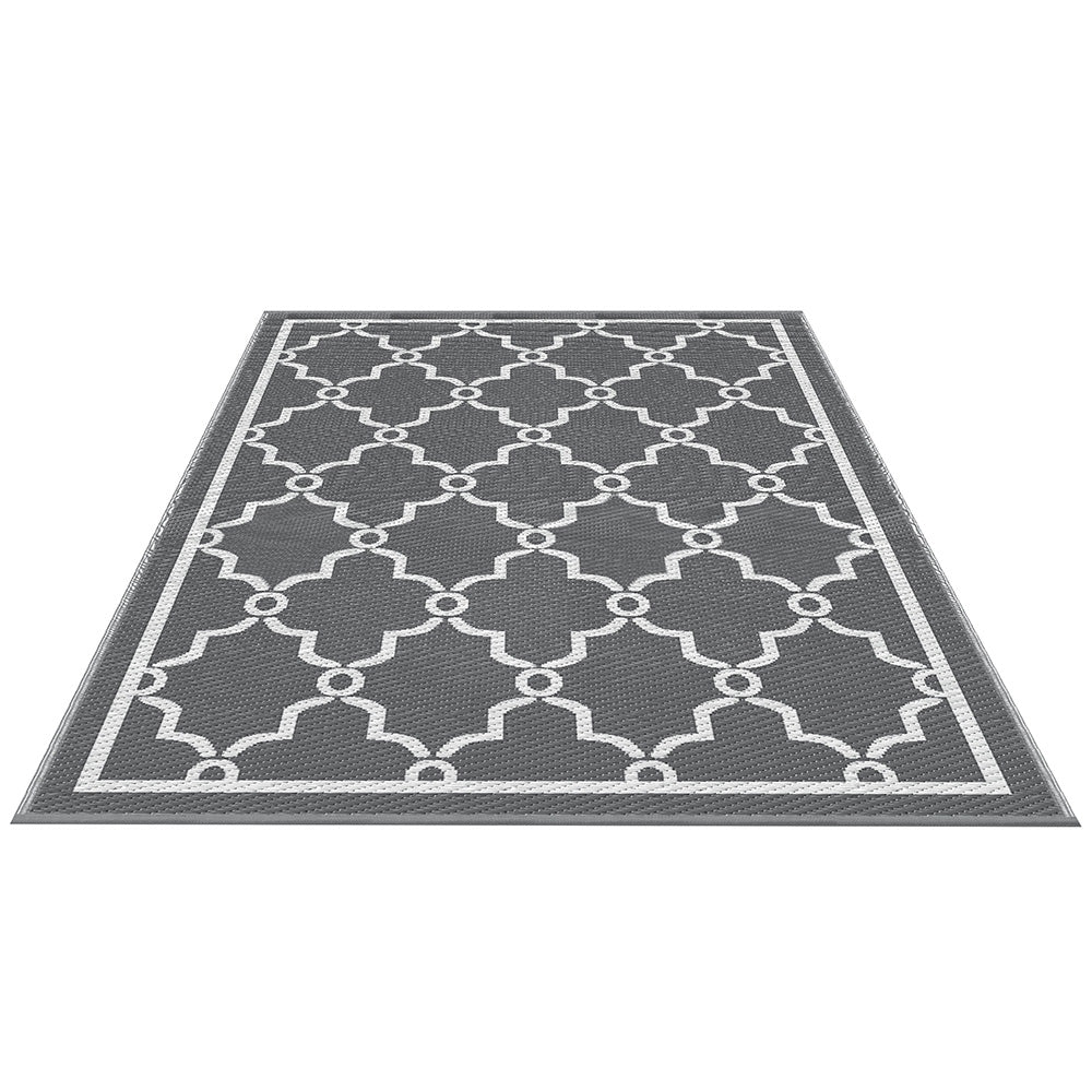 Gray rug with white geometric pattern on a white background