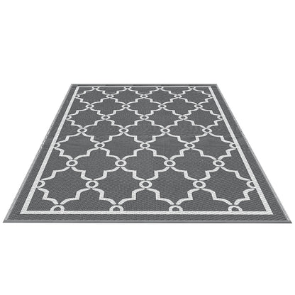 Gray rug with white geometric pattern on a white background