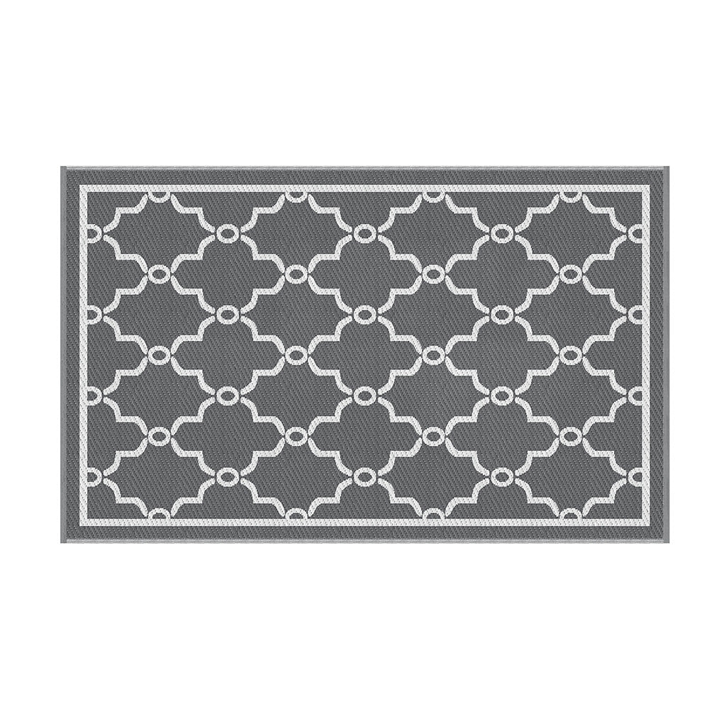 Gray and white geometric patterned rug on a white background
