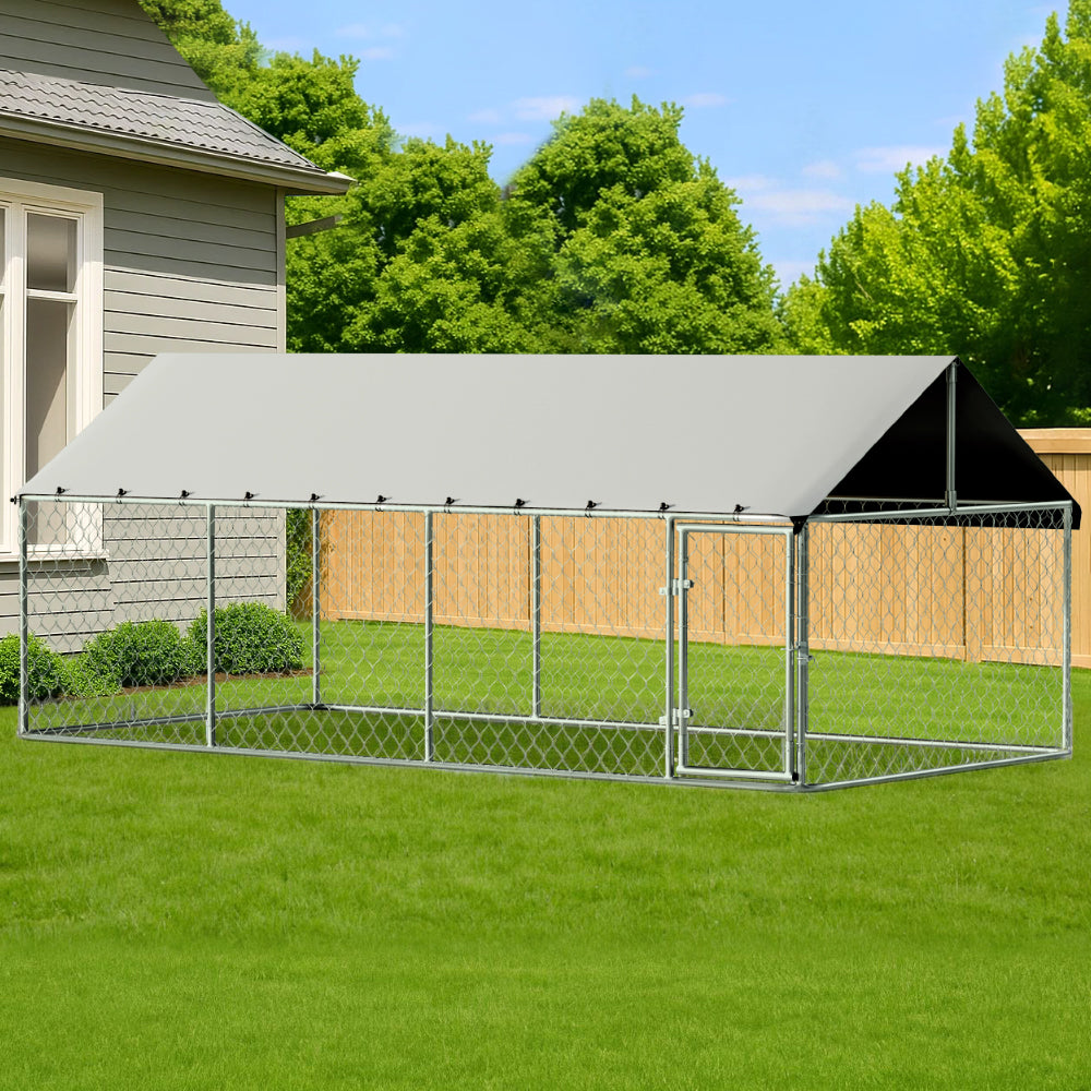 Large outdoor dog kennel with a roof in a backyard setting