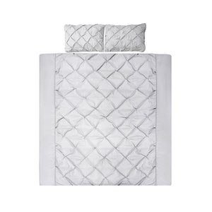 A grey quilt cover set with diamond pintuck design, including two pillowcases, displayed on a bed.