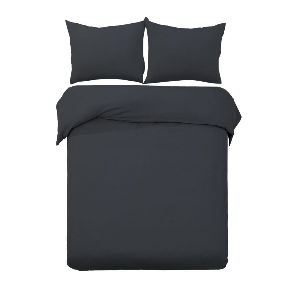 A black quilt cover set including two pillowcases on a bed, displayed against a white background.