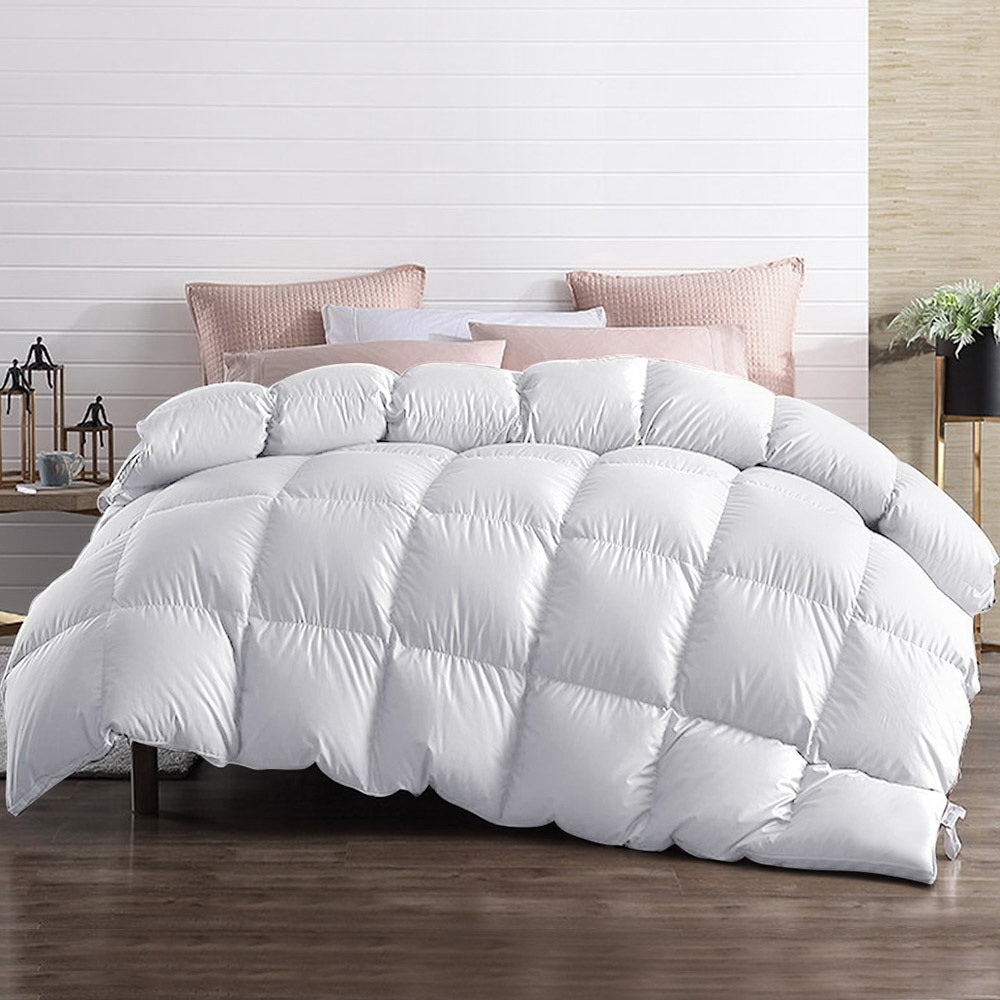 A white, downproof cotton quilt cover displayed on a bed, showing a puffy, plush texture indicative of softness and comfort.