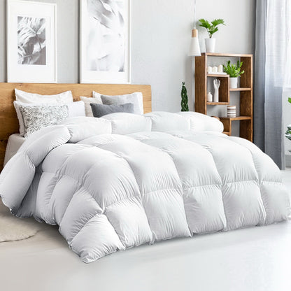 A luxury white goose down feather quilt on a super king size bed, with a light color cotton cover.