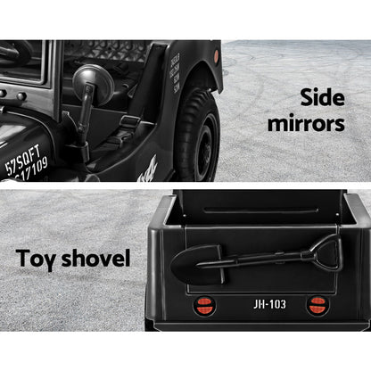 Black toy truck with side mirrors and a toy shovel on a gray surface