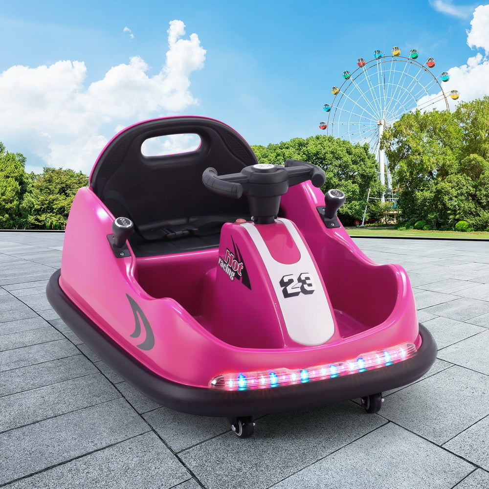 Pink bumper car on a paved area with a Ferris wheel and trees in the background