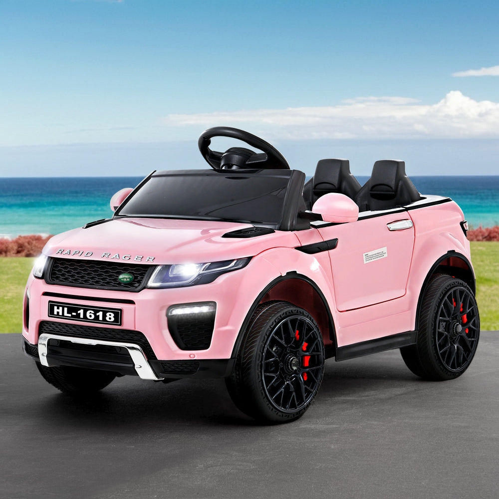 Pink toy car resembling a luxury vehicle on a road with a scenic background