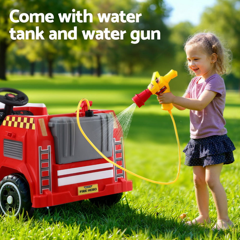 Child playing with a toy fire truck and water gun in a park