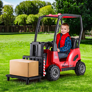 Child playing with a toy forklift on a grassy area