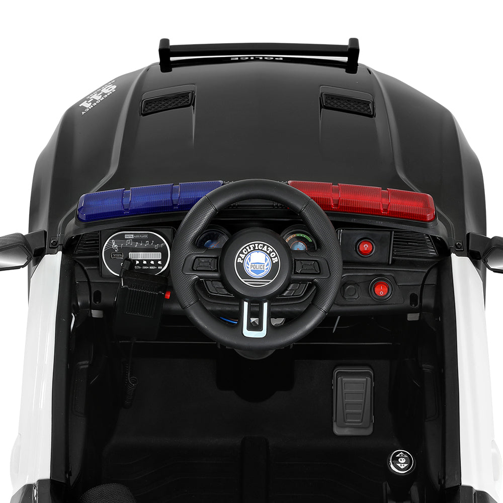 Close-up of a toy car's dashboard with steering wheel and controls on a white background