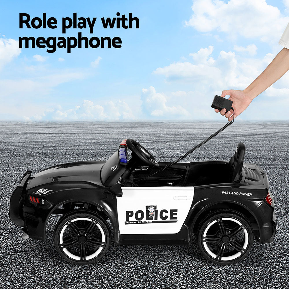 Toy police car with a megaphone held by a hand against a blue sky.