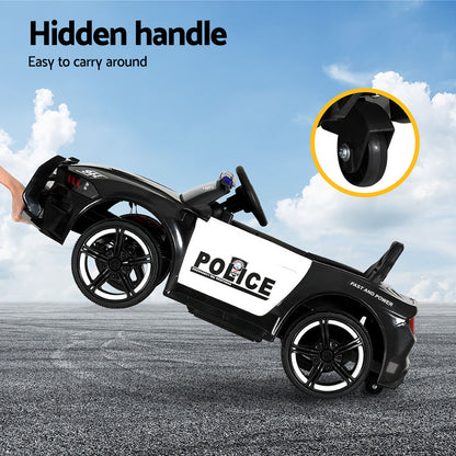 Children's police-themed toy car with a hidden handle on a road with a blue sky background.