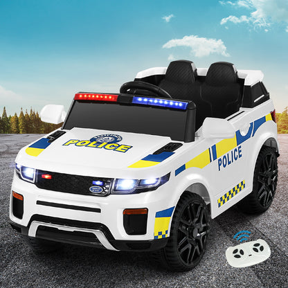 Children's toy police car with lights and a remote control on a road.