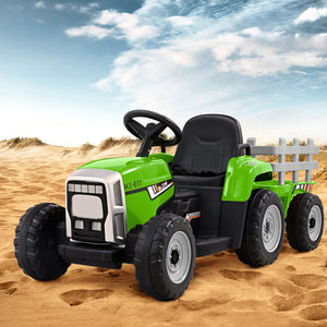 Toy tractor with a trailer on sandy terrain under a blue sky