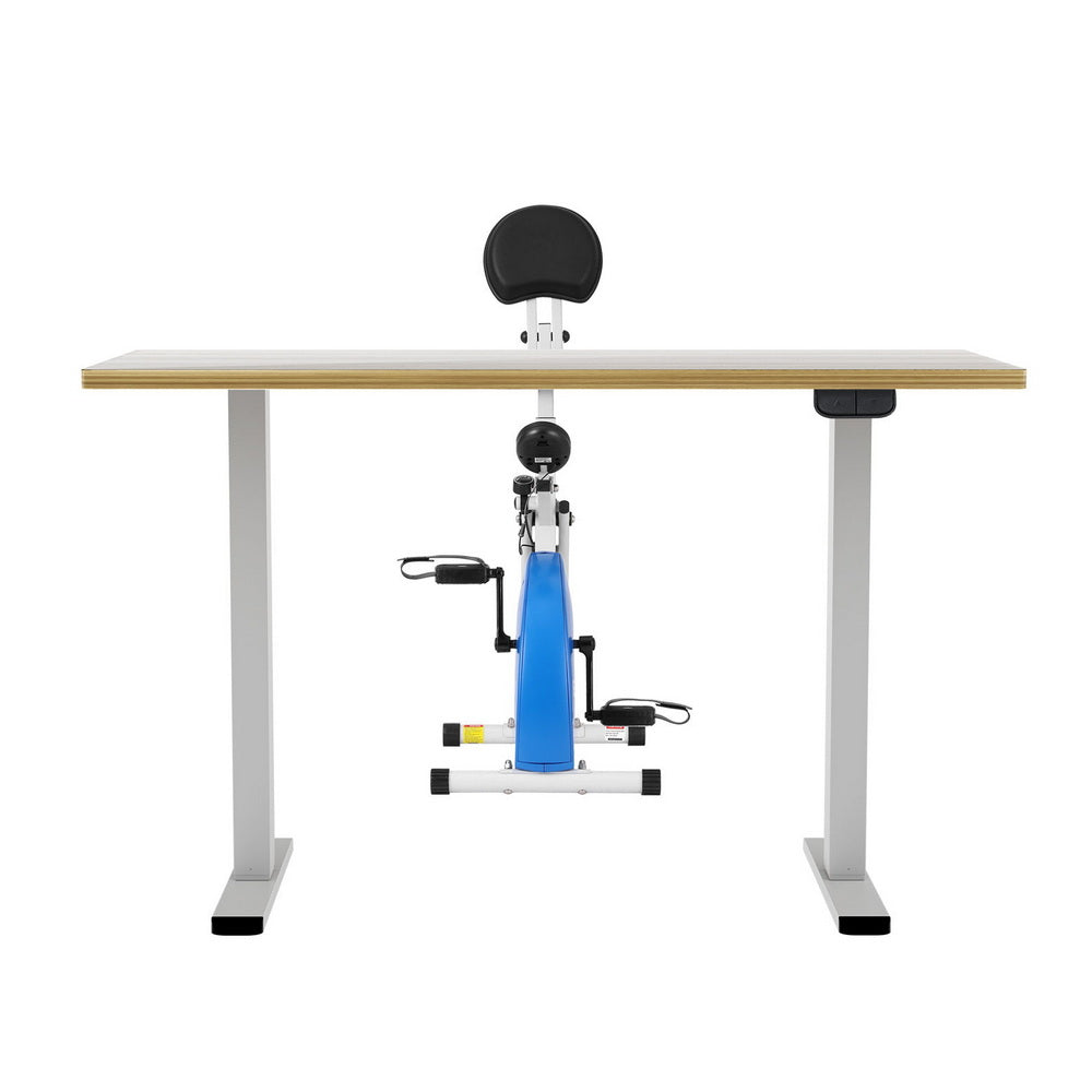 Exercise bike attached to a standing desk on a white background