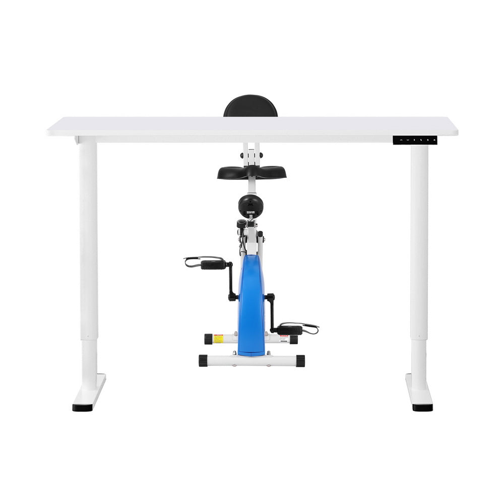 White standing desk with a blue and black exercise bike attachment on a white background