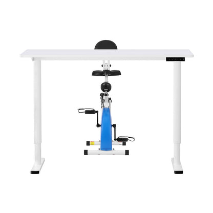 White standing desk with a blue and black exercise bike attachment on a white background