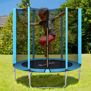 Child jumping on a blue trampoline with safety net padding in an outdoor setting.