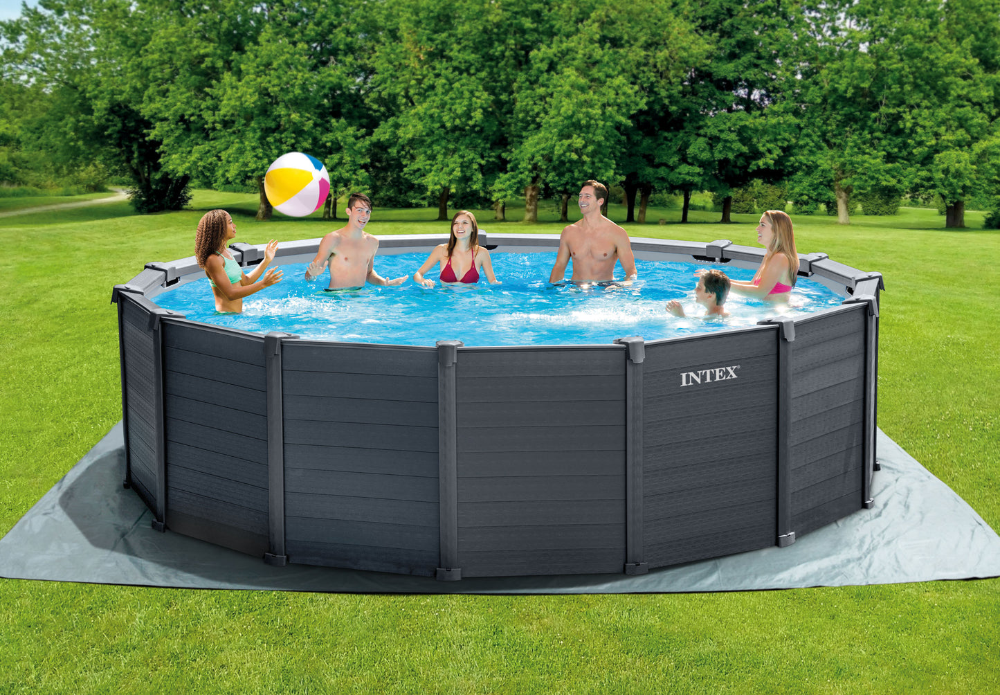 Intex above-ground pool with people enjoying a swim on a grassy lawn