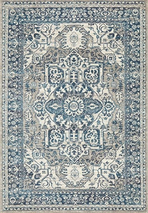 A rectangular blue and beige floral pattern area rug.